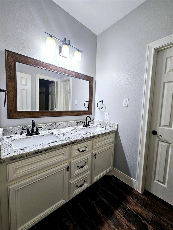 Full Jack and Jill bathroom allowing access between bedrooms #3 and #4.  The door to the left leads to bedroom #4. New faucets installed May 2025, never used.