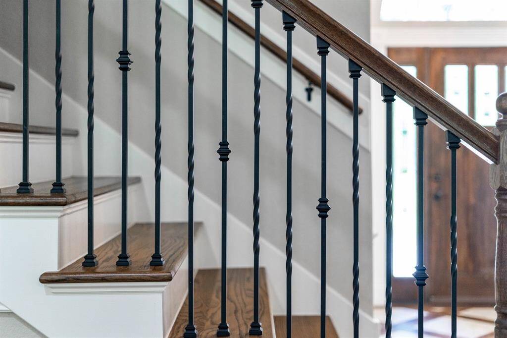 This stair railing is so pretty adorning the pathway up to the media room, bonus room, loft, 1/2 bath and walk in attic!