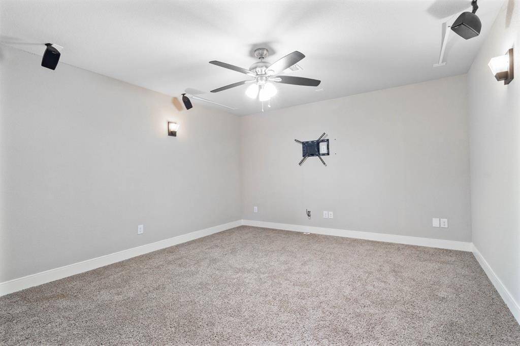 This media room is sure to make you feel like you are in the theater.  Wired for surround sound and complete darkness, sit back and enjoy the show. Speakers do not convey with the home.