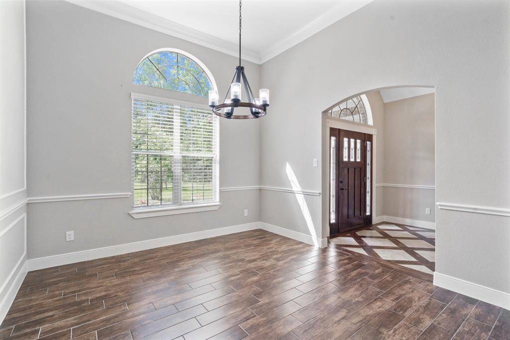 Another view of this gorgeous formal dining room looking at the foyer. The natural light coming through the windows in this room, as well as the front door and front window is beautiful.  Wouldn't you agree?