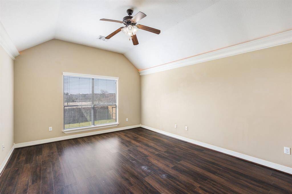 Primary has vaulted ceilings and is oversized. It is located on opposite side of the other secondary bedrooms.