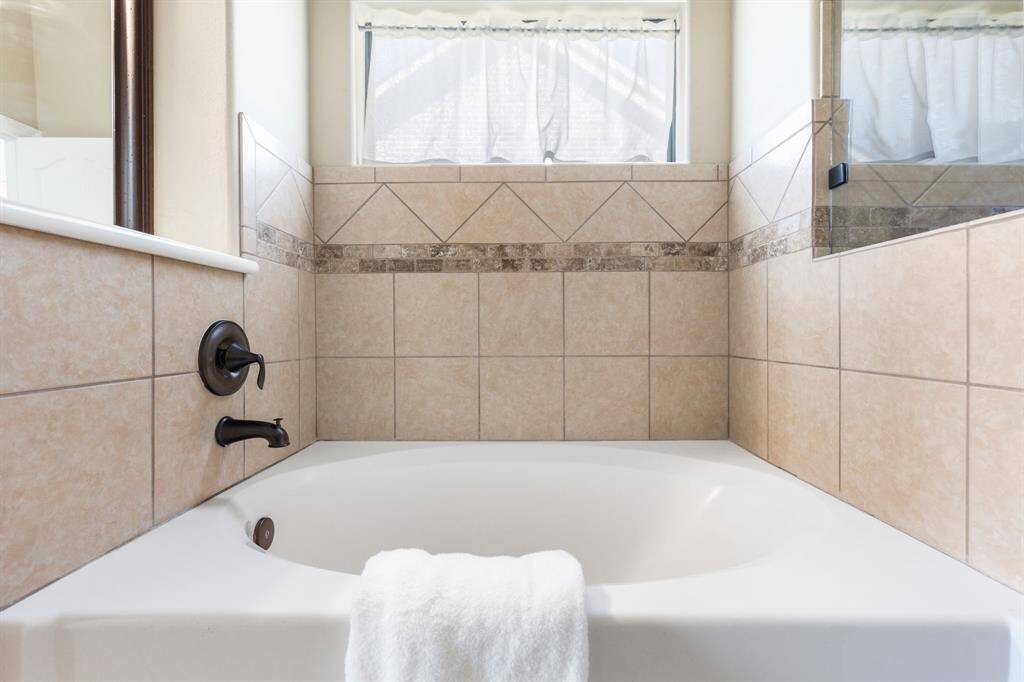 Soaker tub with back window for natural light.