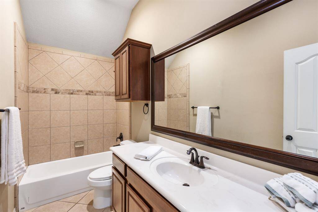 Extremely oversized secondary bathroom is shared by secondary baths and has tons of storage.