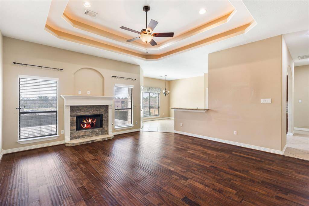 Expansive living room with tons of natural light opens to the kitchen and dining area.
