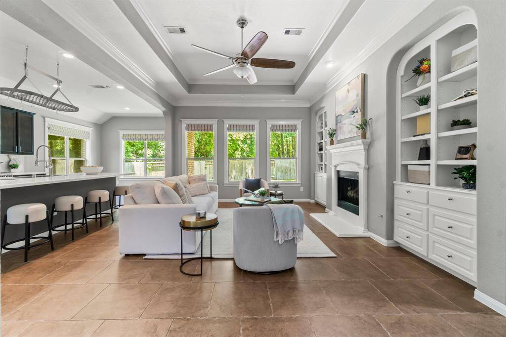 Built ins, fireplace, and ample windows in the living room