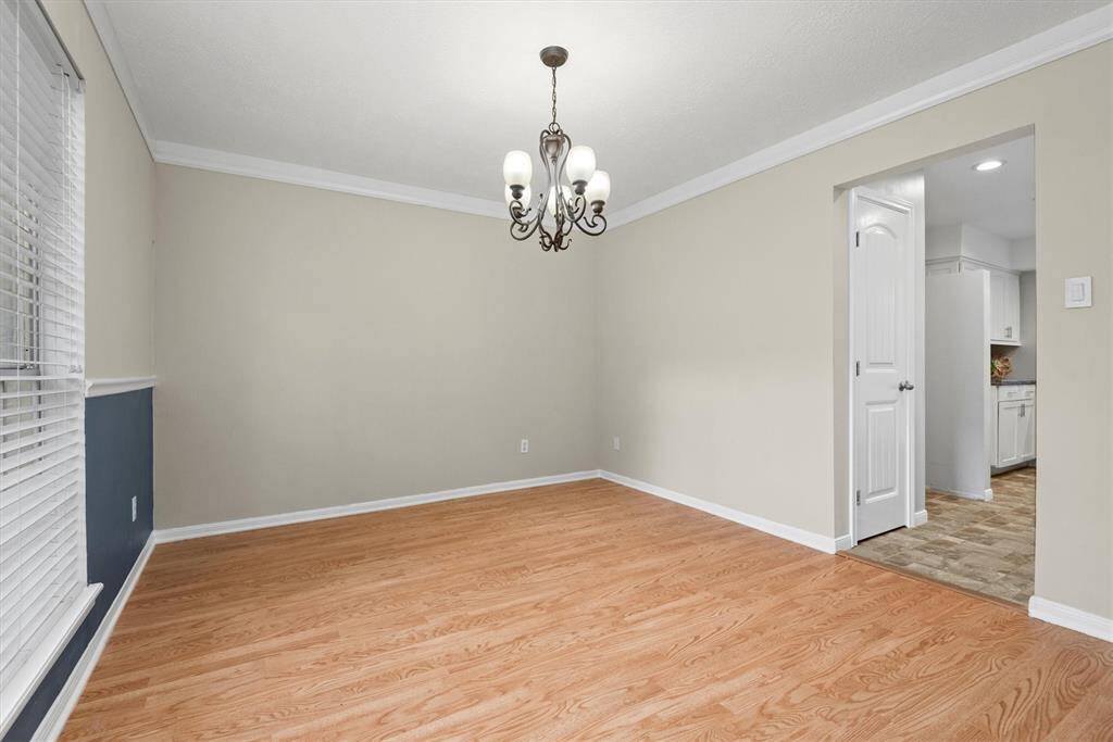 Here is the formal dining space, ideal for family meals and entertaining guests. Note the classy wood trim and paint colors.