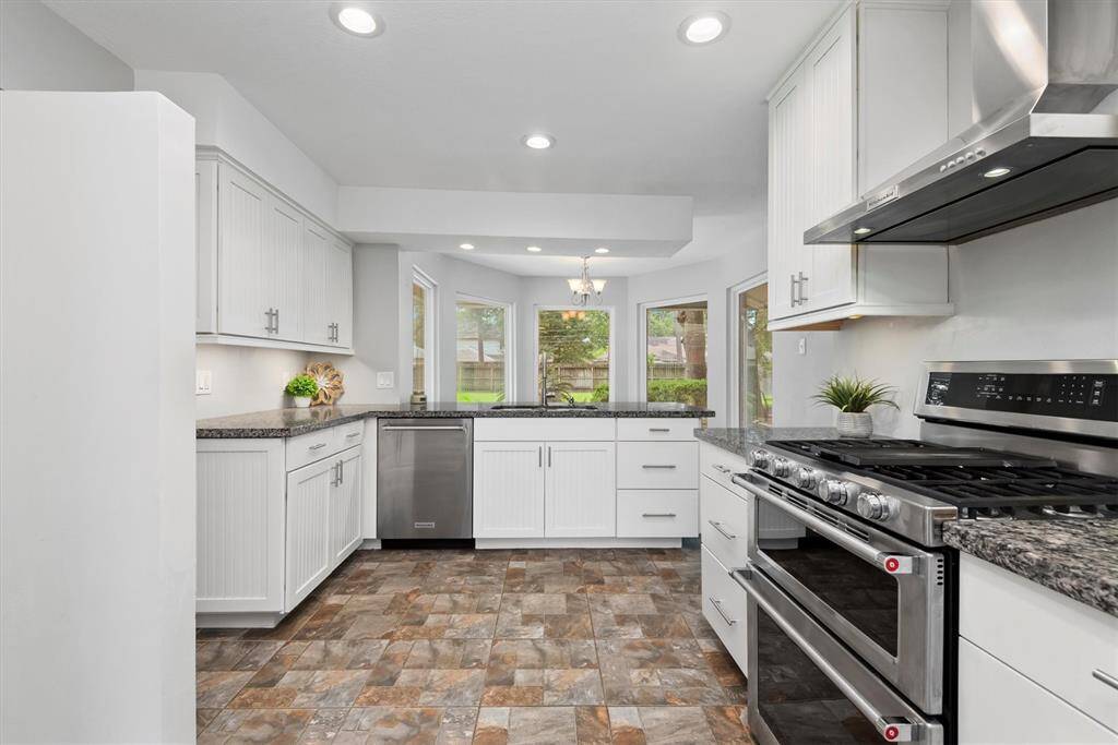 Top of the line stainless appliances can be found in this awesome kitchen. The wall to the left creates a custom built-in look and place for your refrigerator.