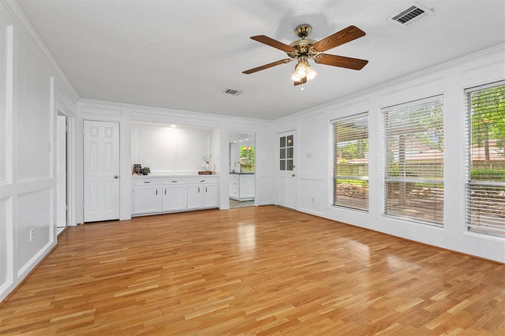 There is a convenient dry bar nestled in the living room, perfect for entertaining with built-in cabinetry and ample counter space for serving and storage.
