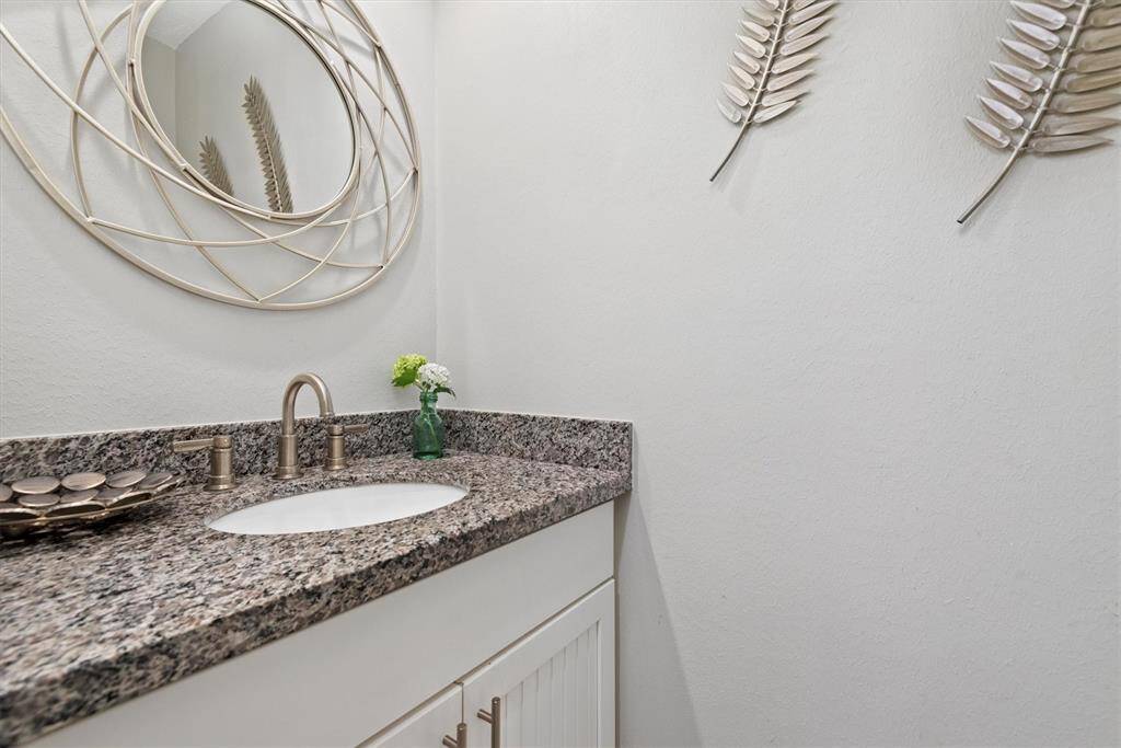 There is half bath on the main level with tasteful finishes. Ideal for guests and convenience.