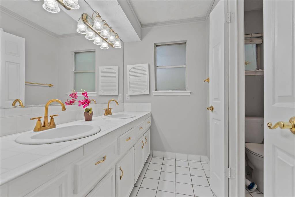 The primary bathroom features a large vanity with double sinks.
