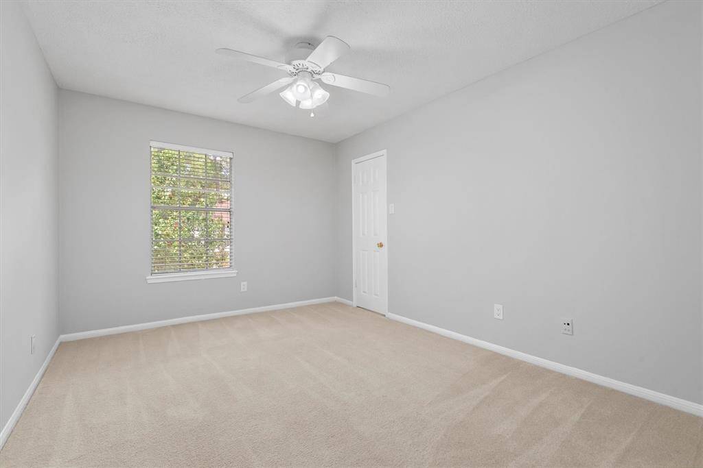 Another spacious bedroom, offering a walk-in closet, versatility, and plenty of natural light. Perfect for family or guests.