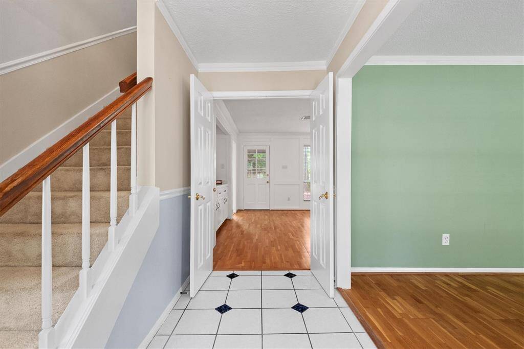To the right is the formal living room which can be used as a home office, library, sitting area, etc. Straight ahead is the entrance to the main living area.