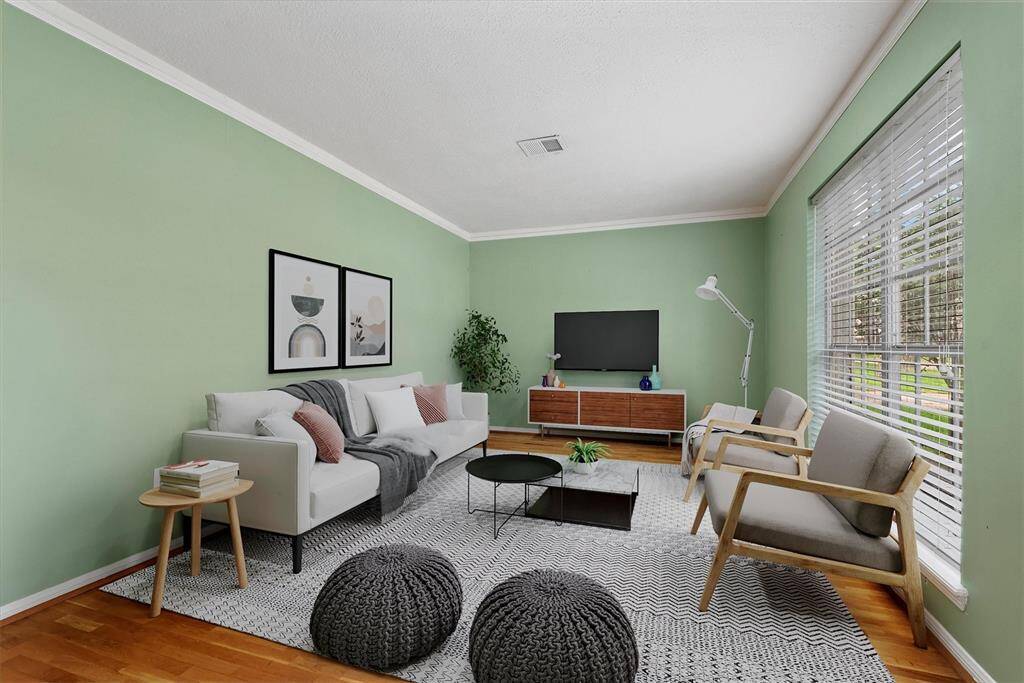 This elegant formal living room is perfect for a cozy sitting area, home office, or additional entertaining space. Virtually staged.
