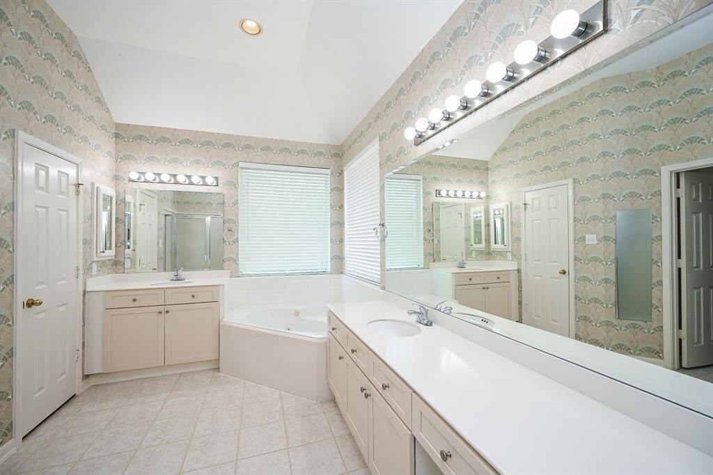 Primary ensuite with lots of natural light, double sinks, separate tub and shower.