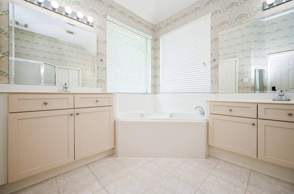 His and Her vanities large soaking tub and new mirrors.