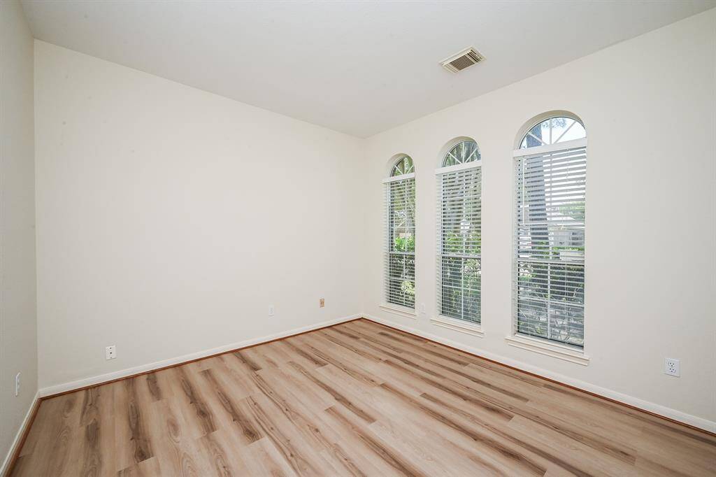 Study or formal living room with wall of windows and fresh new floors.