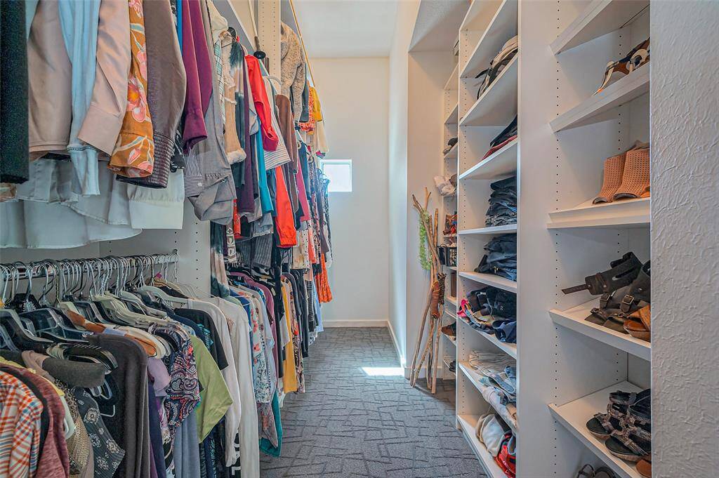 Step down the stairs to the inviting hallway that leads to the garage, laundry, two rooms, and bathroom.