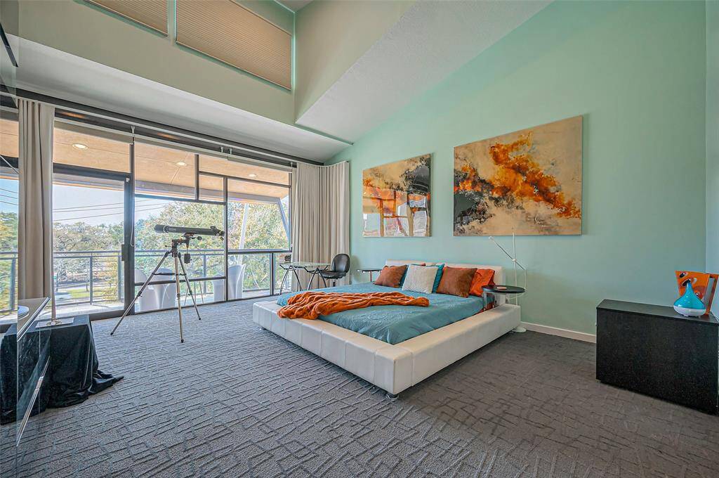Discover this breathtaking primary bedroom, offering spaciousness that effortlessly accommodates your larger furniture pieces, creating a perfect place to relax.