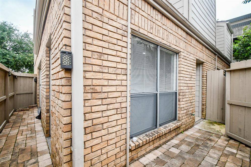 Private patio area fully enclosed by a high privacy fence.