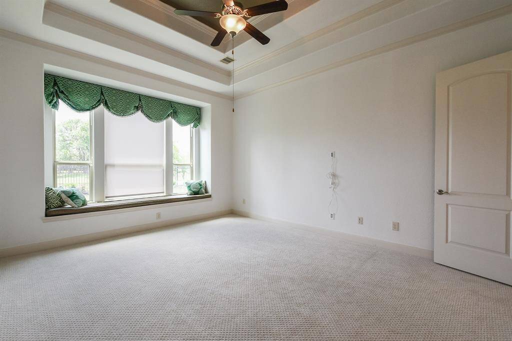 A double tray ceiling offers instant warmth and intimacy to this finely carpeted (all NEW throughout) primary, with the addition of this darling, wide window seat. (See? It's the little unexpected details that make this home special!)