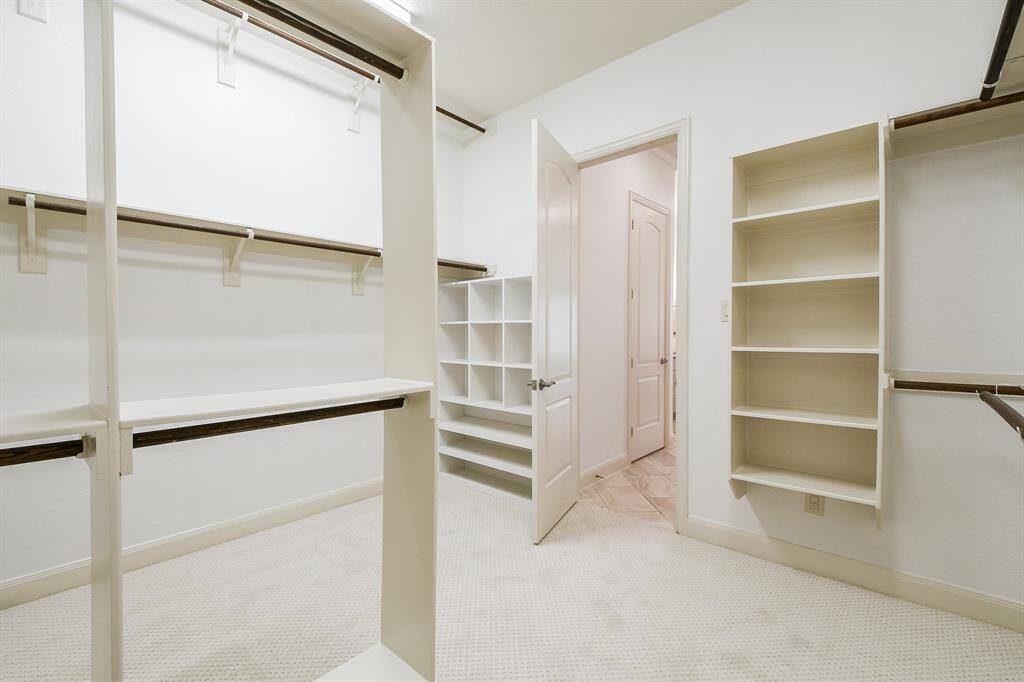 No. This is not a private shopping salon. This is your amazing one-of-a-kind primary walk-in closet, with shelving, cubbies, hanging rods, galore! (Leave breadcrumbs so others can find you.)