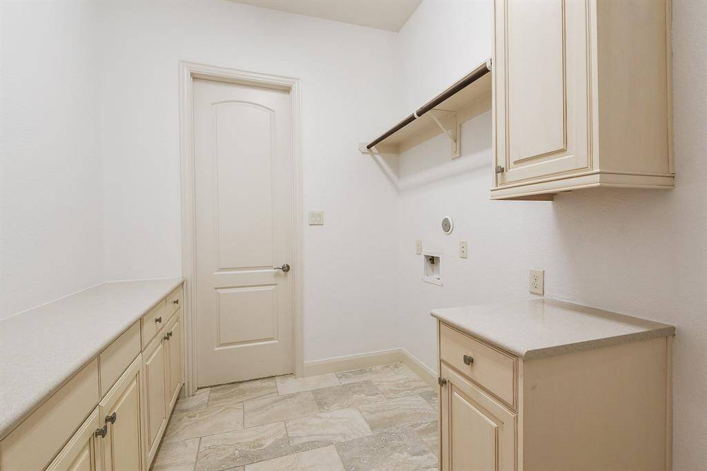 Warm blond toned useful cabinetry and counter space line this incredible utility room. Laundry day may turn into DAYS!