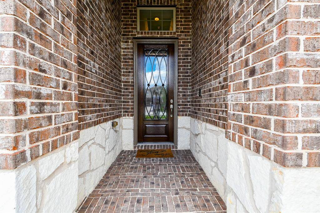 Don't you love this covered entry, with gorgeous brick/stone elevation?