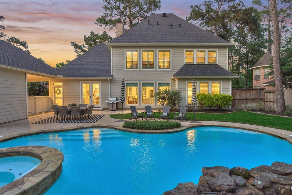 Spacious backyard with pool and spa. The patio area is perfect for outdoor dining and entertaining, offering a serene and private setting.