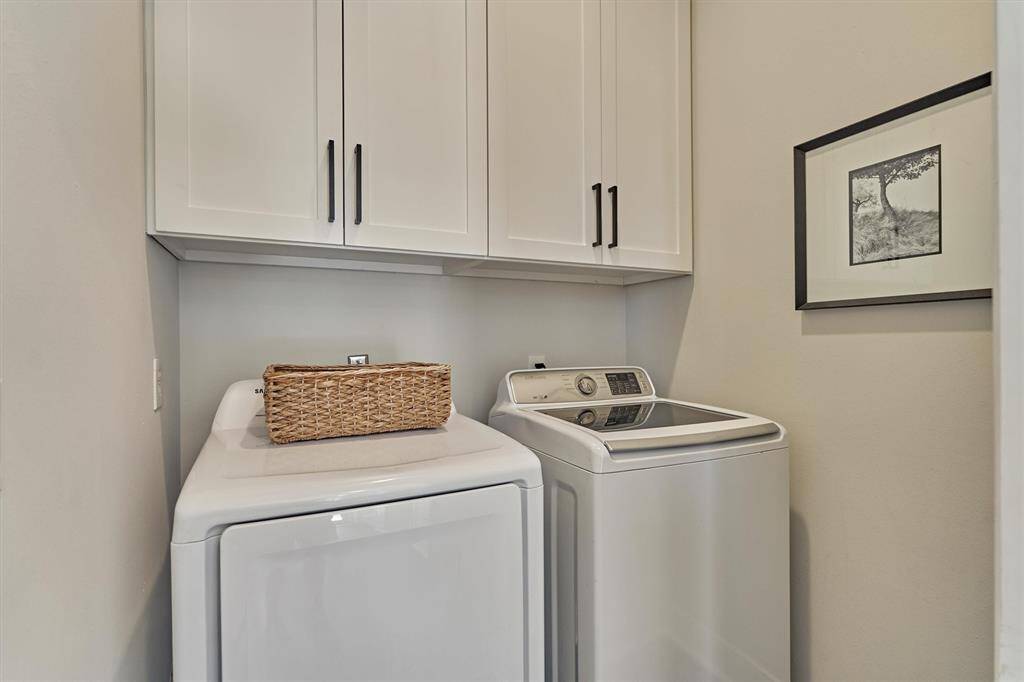 Laundry room with storage cabinets.