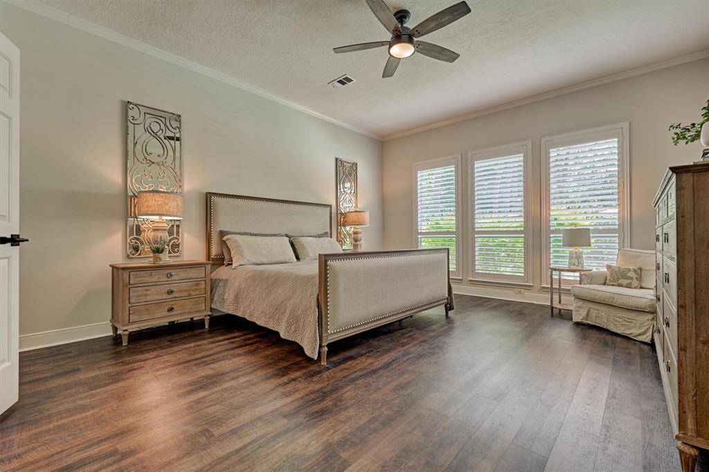 Primary ensuite with wood-style flooring.