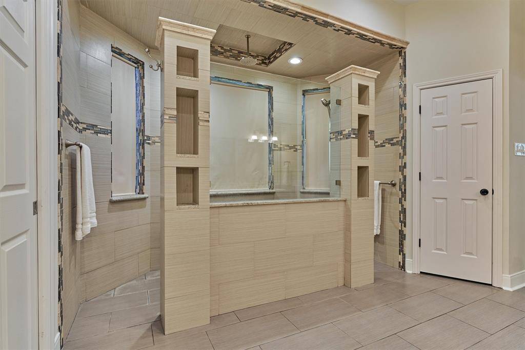 Primary bath features dual-entry walk-in shower.