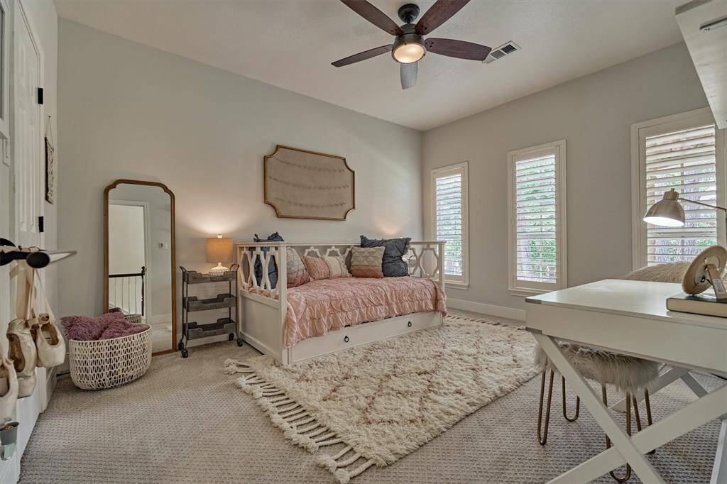 Upstairs ensuite bedroom 3 with shutters and walk-in closet.