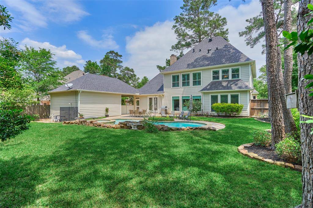 Backyard includes a large grassy area—ideal for a trampoline and/or play system.