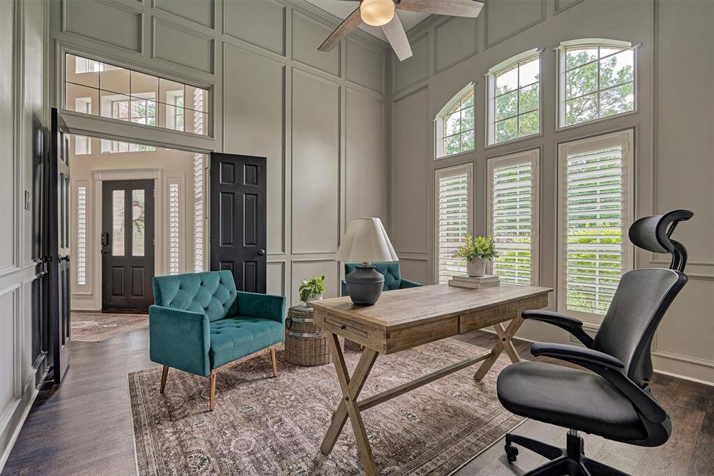 Bright home office with shutters and elegant paneled walls, stylish and functional workspace.