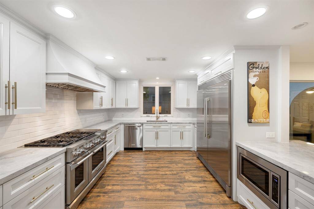 A view of the Kitchen (20 x 12) towards the window.  The Electrolux stainless steel refrigerator/freezer, KitchenAid stainless steel appliances (professional style range with 6-gas burners and 2 ovens, dishwasher and microwave) make any home cook ready to go!
