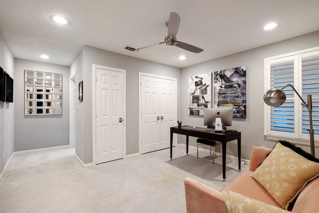 This is the sitting room off the Primary Bedroom currently set up as a Study.  This Study welcomes the owner to the private retreat at the end of the day.  There are 2-closets, Plantation shutters, and carpet leading to the bedroom around the corner out of view.  This flex space could also be a yoga, meditation or workout space (leaving the gym downstairs as Bedroom 5).