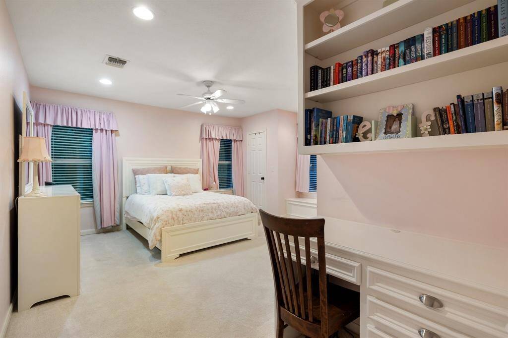 This Bedroom (13 x 13) boasts built-in desk, dual reach in closets, window seat and an en suite bath!  Great for a guest or a permanent resident.  The windows overlook the swimming pool, terraced yard and the bayou.