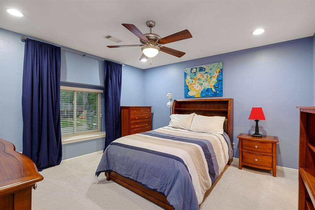 This is one of the secondary bedrooms (13 x 13) that connects with another secondary bedroom through the Hollywood bath.  This bedroom has a large walk-in closet (out of view), recessed lighting and fan with light.