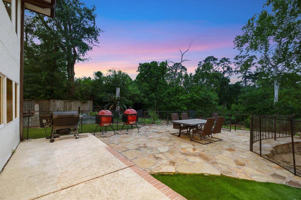The backyard starts with this patio outside the Family Room with the swimming pool to the right of the image, the large flagstone patio dining area straight ahead, the herb and vegetable garden and smoker area straight ahead and to the left of the image.  The grassy yard is terraced down to the bayou.