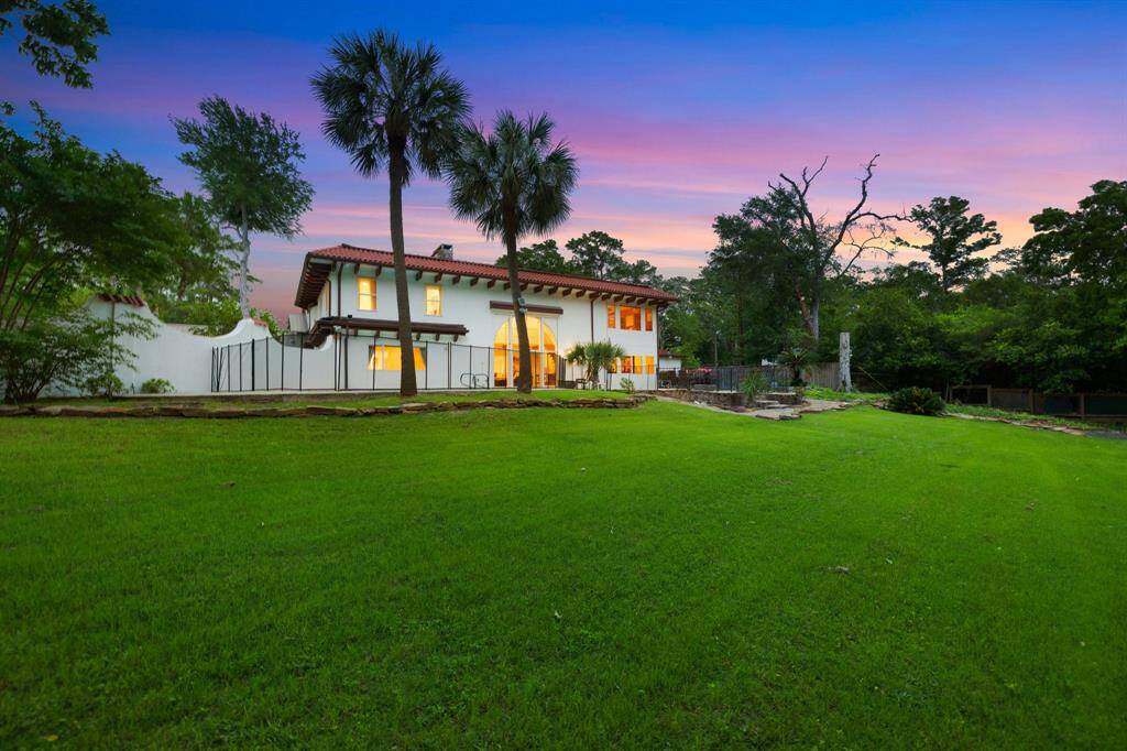 The rear elevation from the lower portion of the terraced yard in this 36,250 SF LOT/HCAD.