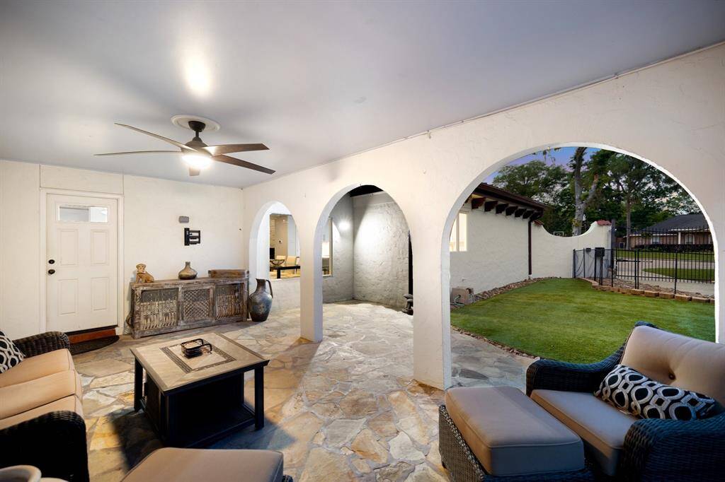 The covered loggia off the gated driveway opens to the turfed side yard ideal as a separate area for young children or pets away from the swimming pool.  Plenty of room to install a playscape system here. This is a carport providing additional covered parking.