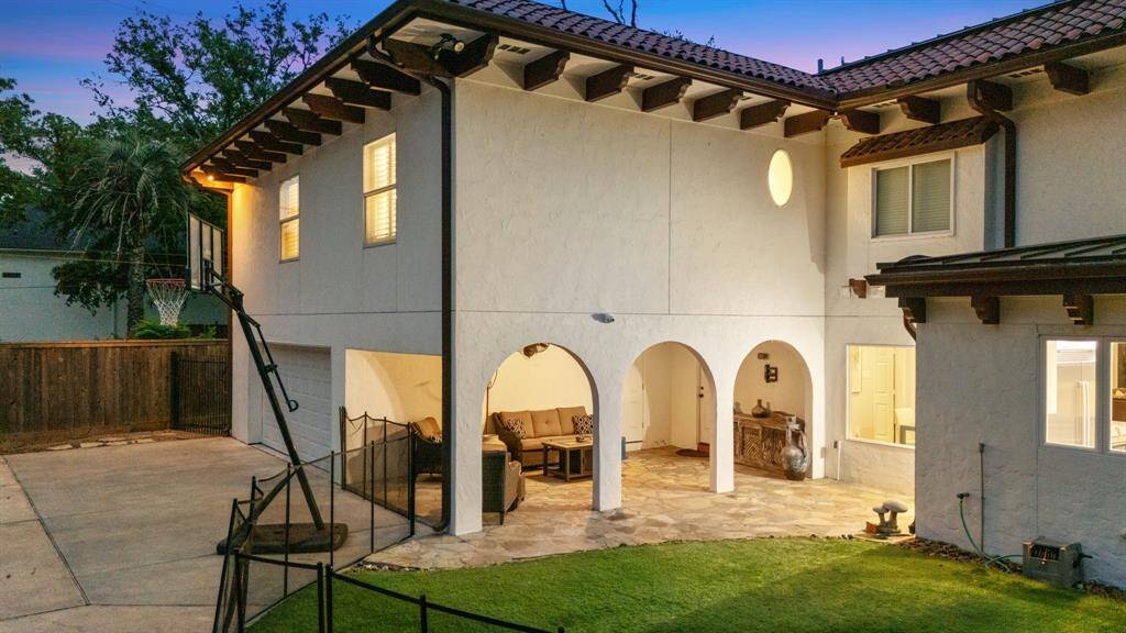 This image includes the Primary Bedroom suite that was added by the current owner in 2018 over the garage and covered loggia/carport which opens to the turfed yard that is separate from the swimming pool and bayou side of the property.  Wonderful gated driveway too!