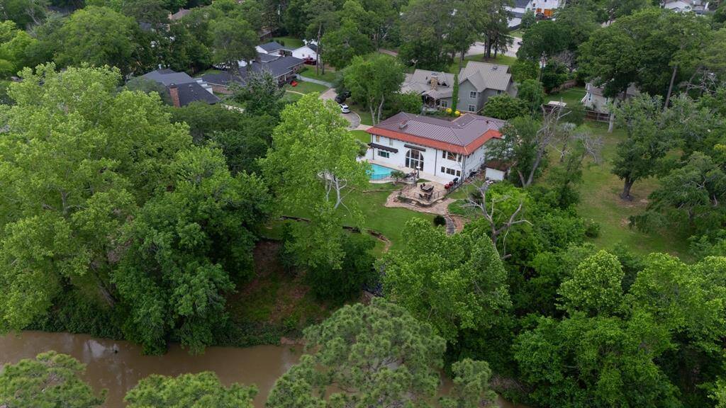 This drone image is taken towards the pool and terraced side yard.