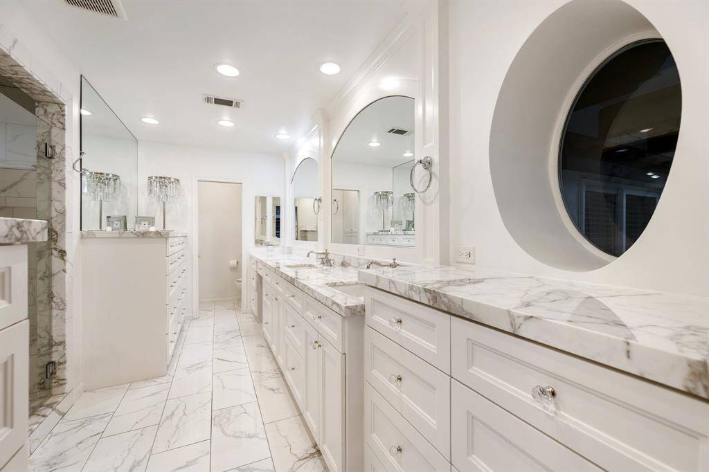 Now THIS is a gorgeous Primary Bath!  Double (Calcutta marble) vanity complete with make-up knee space, large shower (with 3-showerheads), additional built-in dresser and private water closet with linen cabinets.  Cabinets include soft close hinges.
