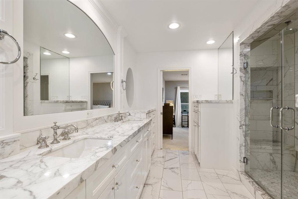 A view of the Primary Bath toward the shower and built in dresser.  Beautiful finishes abound in this 2018 added Primary Suite. Note the size of the shower!  Wowza!
