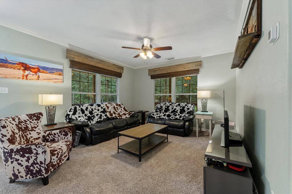 Charming living room with views of the surrounding woods. Custom Window Blinds Installed 2018 throughout downstairs.