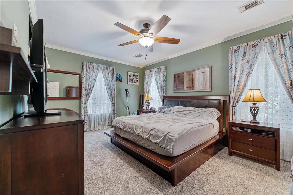 Primary bedroom with serene views of the woods.
