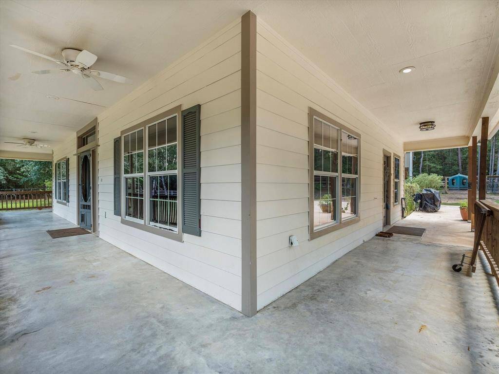 Anoter view of the covered porch with ceiling fans.
