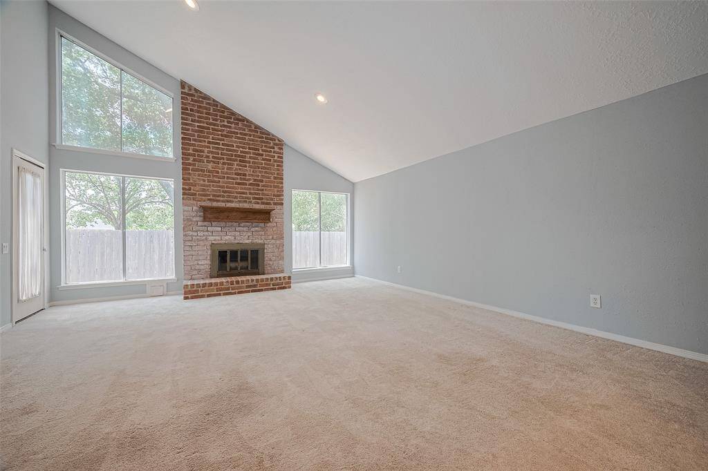 Cozy brick fireplace & huge windows!