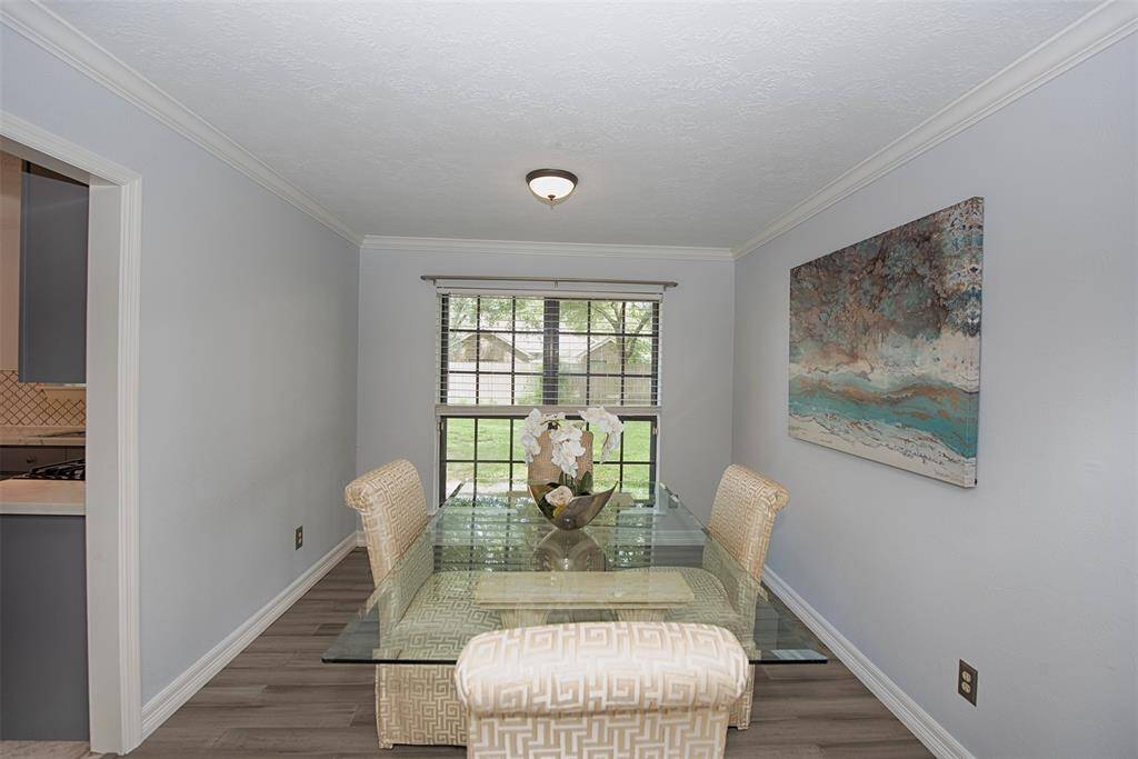 Formal dining room with the same gorgeous floors and lovely views of the large backyard.